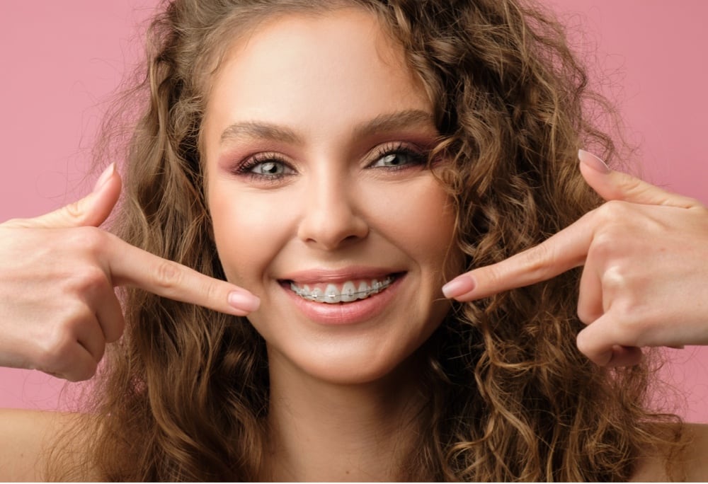 teen girl with clear ceramic braces smiling